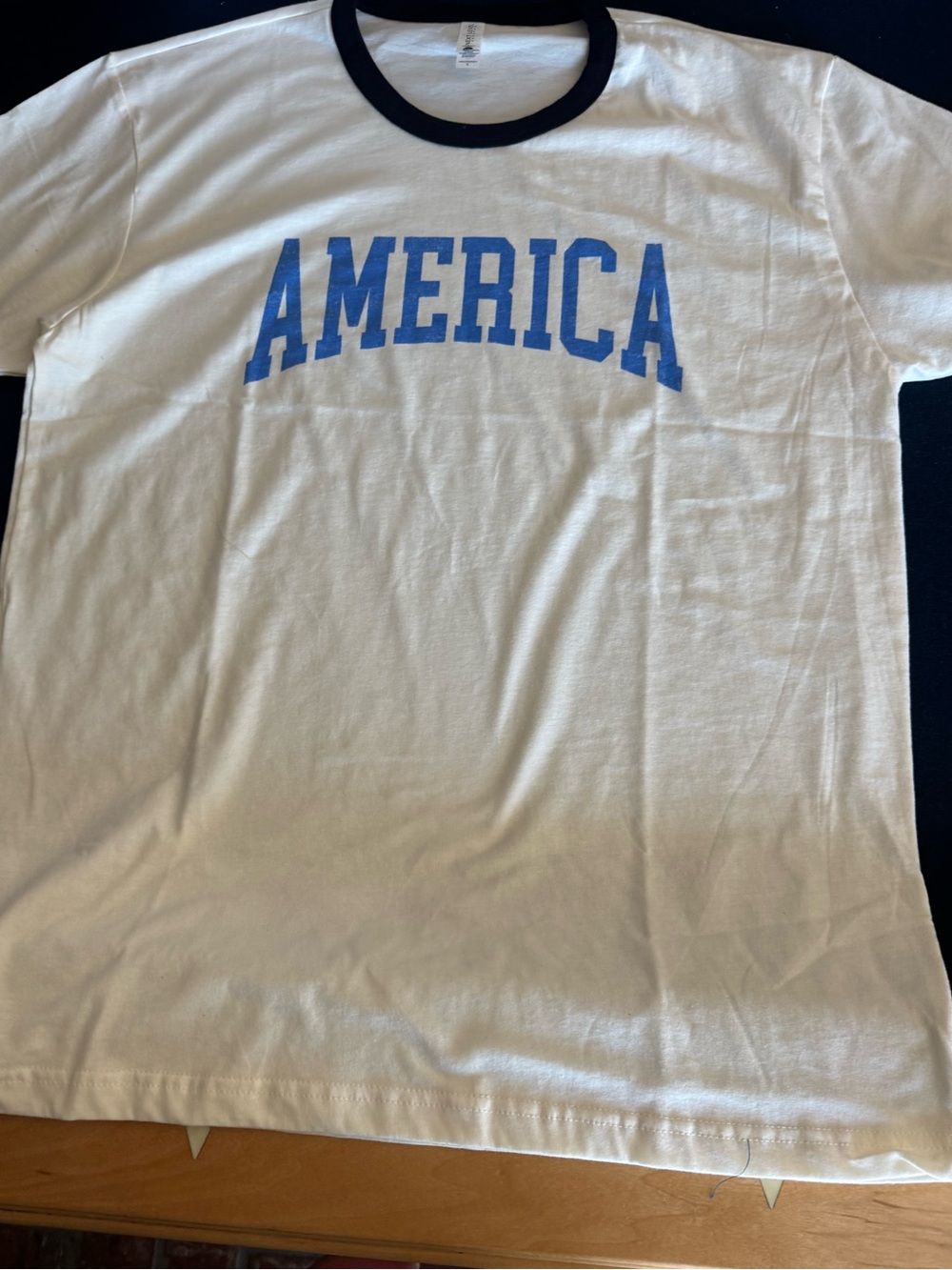 Next Level Apparel Winter White Tee w/Black Trim& AMERICA in blue🇺🇸unisex